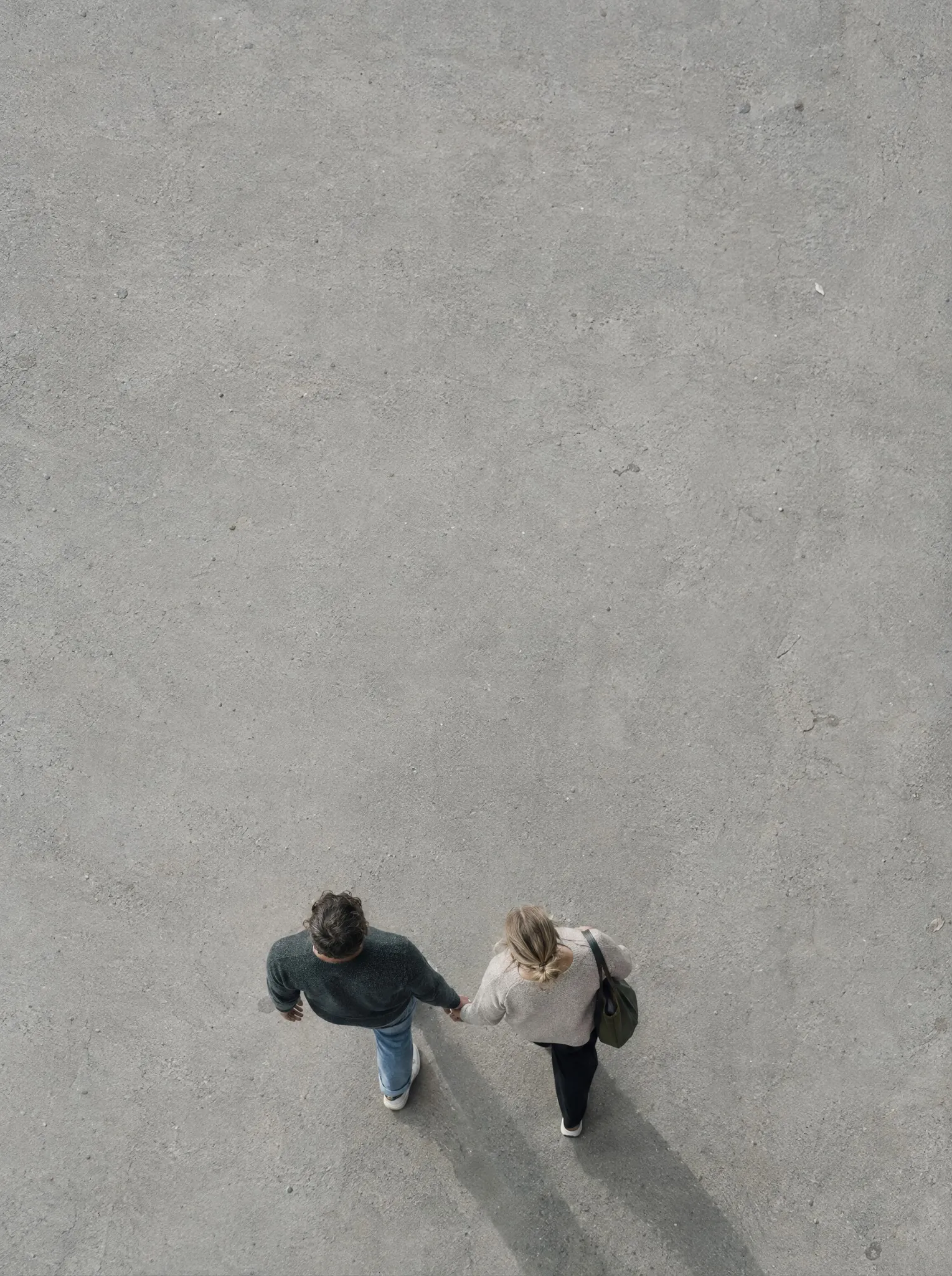 Two people walking side by side, seen from above